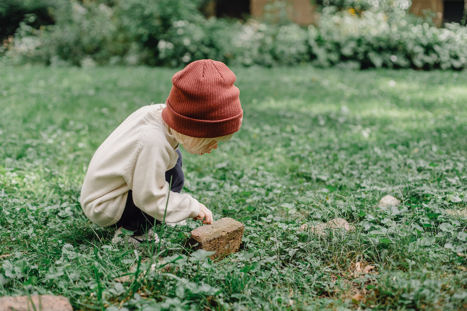 curious little boy playing with brick
