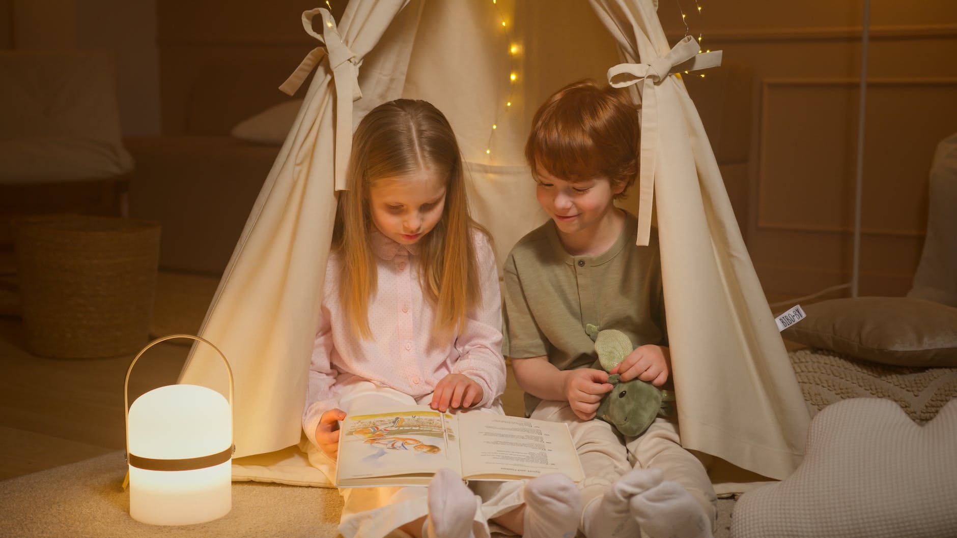children reading a book inside a room