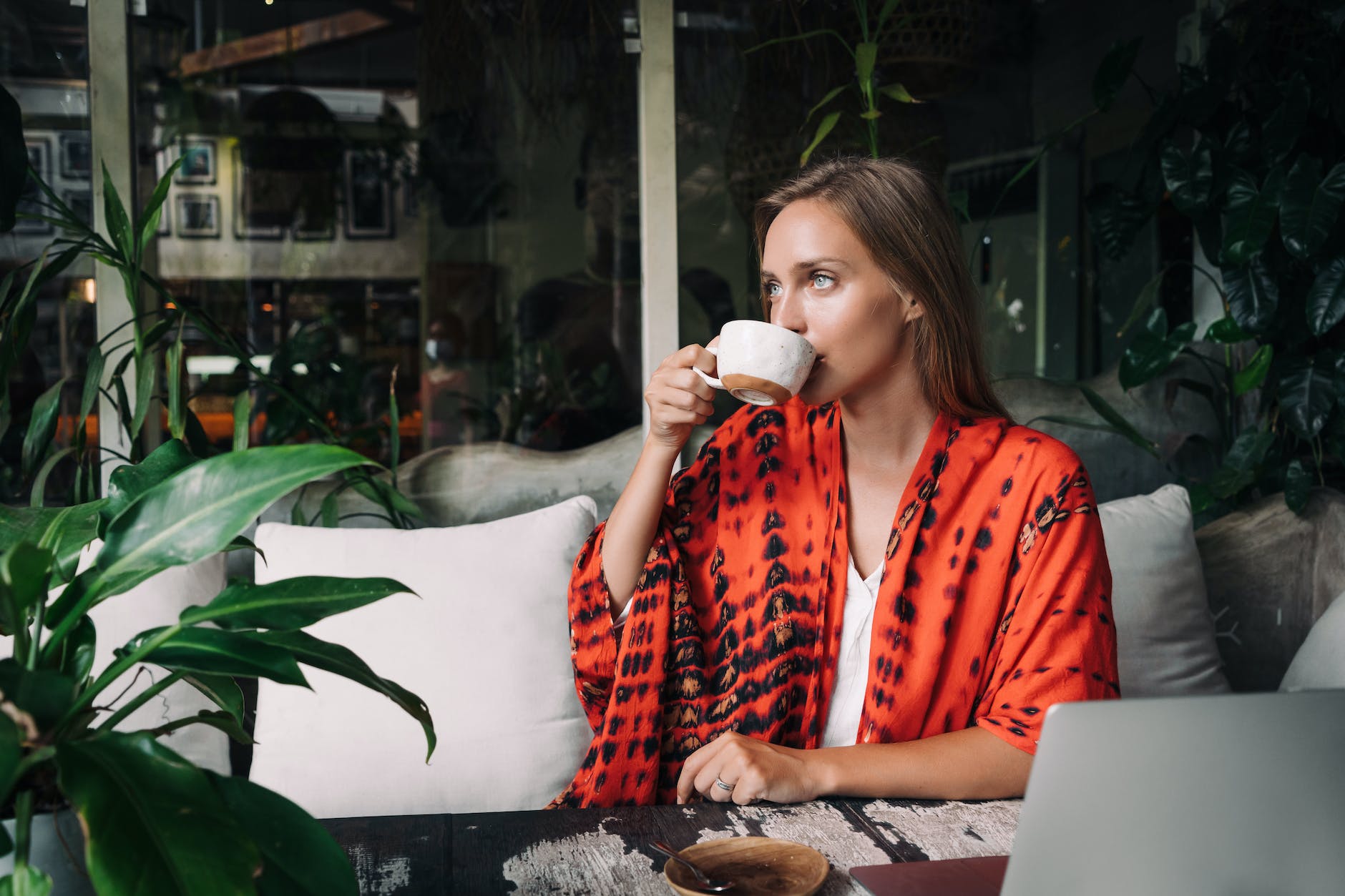 a beautiful woman drinking from a cup