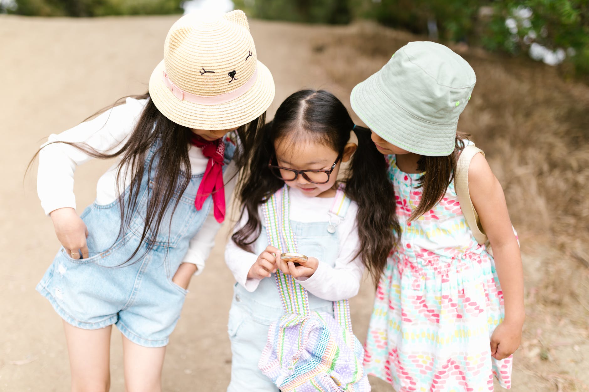 little girls looking at a compass