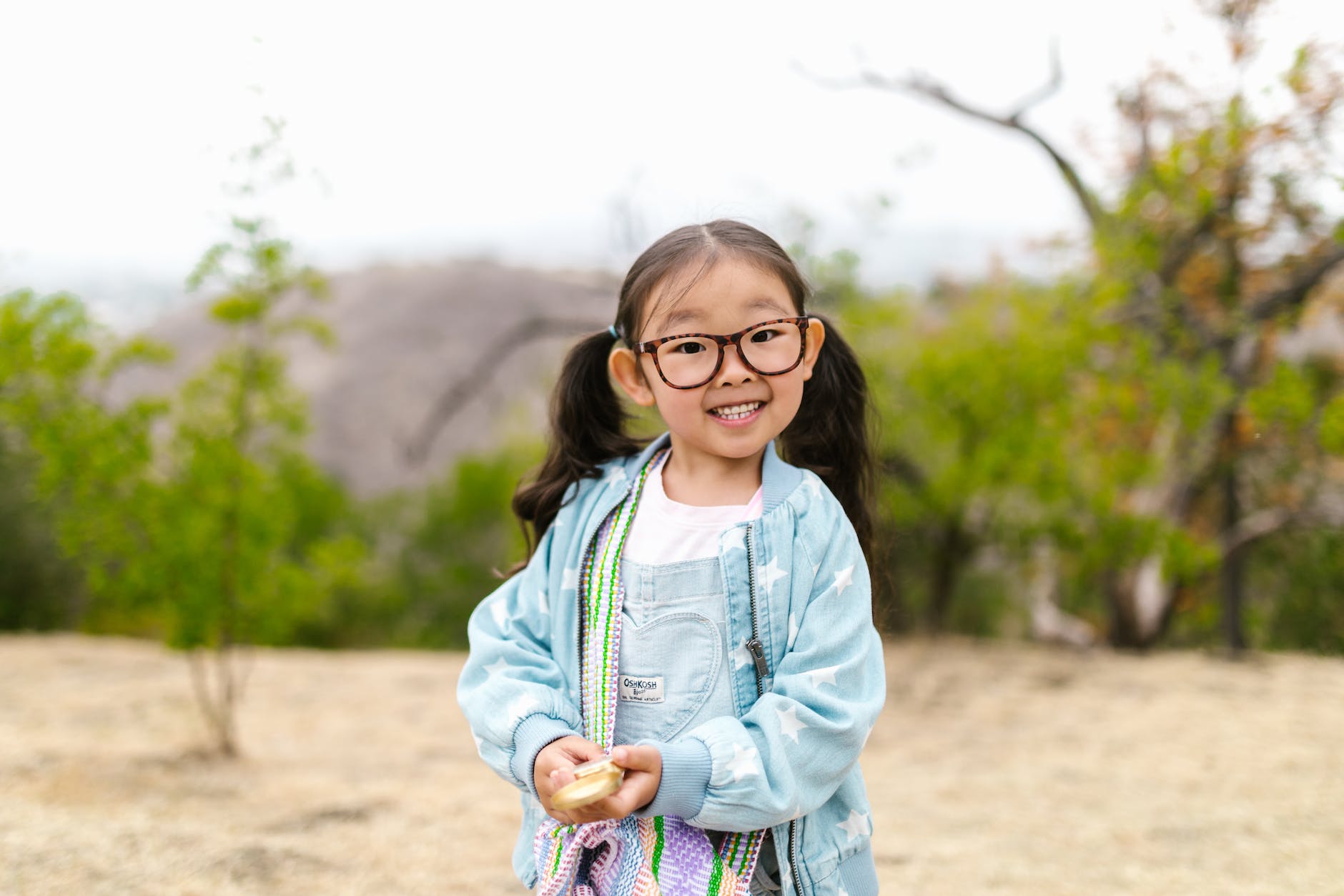 cute little girl holding a compass
