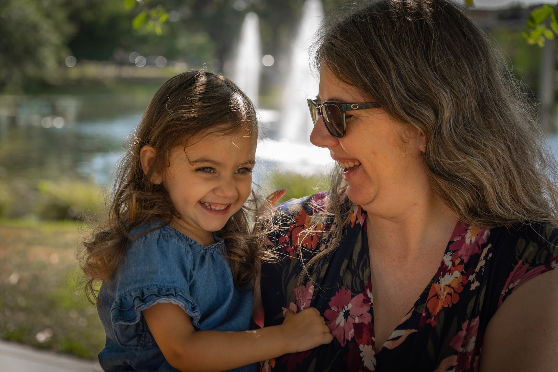 a woman carrying her daughter and smiling